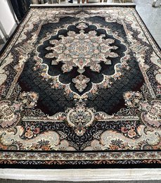 Large dark blue area rug with intricate floral and geometric patterns, suitable for living rooms or bedrooms.