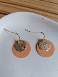 Peach gold hoop earrings with glittery accents. Circular shape with a mix of metallic and matte finishes.
