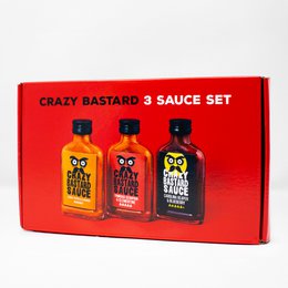 Crazy Bastard hot sauce set, three bottles orange red black, skull face design, spicy condiment gift box.