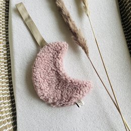 Soft, plush pacifier cloth in a moon shape with a teddy bear design in a light pink color.