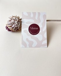  A Mother's Day card with a pink and white abstract pattern and a burgundy circular logo. The card is simple and elegant, suitable for celebrating a wonderful mom.
