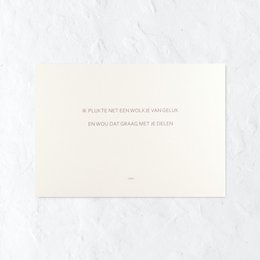 A simple, elegant greeting card with a handwritten message and a sprig of greenery.