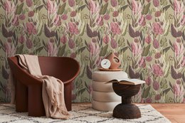 Vintage-inspired floral wallpaper in shades of green and pink, featuring a lush, botanical pattern with leaves and flowers.