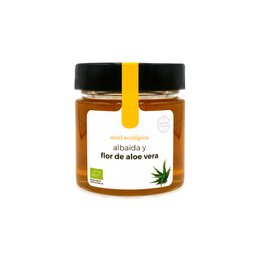 Organic aloe vera flower honey in a glass jar with black lid. The honey has a golden amber color and is labeled as "Aloe vera flower honey".