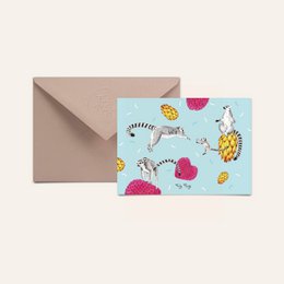 Colorful postcard featuring a ring-tailed maki lemur surrounded by tropical fruits and patterns.