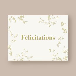 Congratulations card with floral pattern and text in French. Cream-colored card with gold-colored floral design. Text reads "Félicitations" which means "Congratulations" in French.