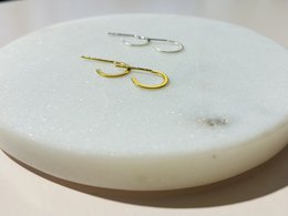 Small half hoop earrings made of 925 sterling silver with a gold finish.