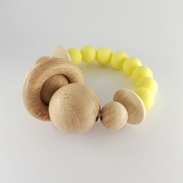 Wooden teether with yellow beads, designed for babies to safely chew on and explore. Features a natural, organic design with smooth, rounded shapes.
