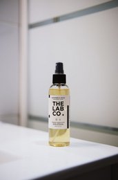 Dry wash mist in 60ml and 150ml sizes, made by The Lab Co. for laundry detergent.