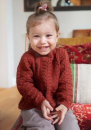 Cozy red cable knit cardigan for baby, available in sizes 18-24M and 24-36M.