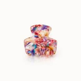 Small confetti-patterned hair clip with a claw-style grip for securing hair.
