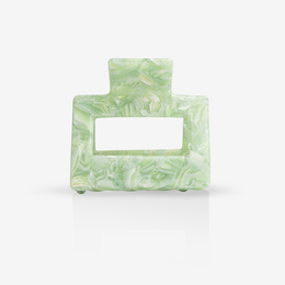 Green hair clip with floral pattern and rectangular shape.