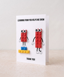 Mother's Day greeting card with red Lego brick characters, cute figures, heartfelt message, multilingual card design.