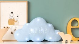 A blue glitter cloud-shaped musical night light with the text "Pretty dreams" printed on it. The night light is designed for babies and features a soft, soothing glow.