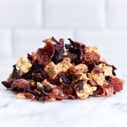 Redberry Garden tea, a blend of dried berries and fruit pieces. Available in 100g and 450g resealable pouches, as well as a 100g tin. The tea has a rich, fruity flavor and aroma.
