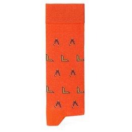  'Orange socks with a repeating pattern of black and multicolored lightning bolt shapes.'

The product is a pair of socks with an orange background and a repeating pattern of black and multicolored lightning bolt shapes. The socks are available in sizes EUR 35-40/UK 3-6/USA 4-7 and EUR 41-46/UK 7-12/US 8-13.