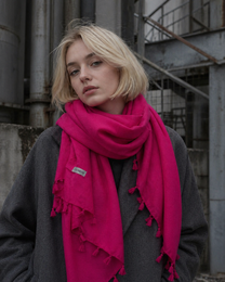 Bright magenta pink cashmere scarf, soft drape, fringed edges, luxurious wrap style.