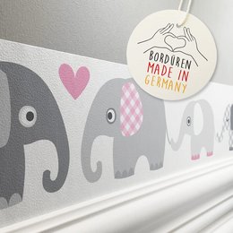 The product image shows a border wallpaper design featuring grey and pink elephants. The wallpaper is suitable for a kids' room and has a playful, whimsical style.
