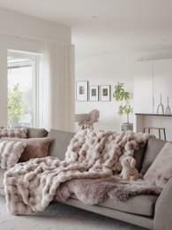 Large, cozy tie-dye sand-colored blanket made of soft, plush faux fur material. Ideal for snuggling up on the couch or bed.
