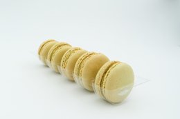 Pistachio-flavored macarons, a delicate French pastry with a smooth, creamy filling.