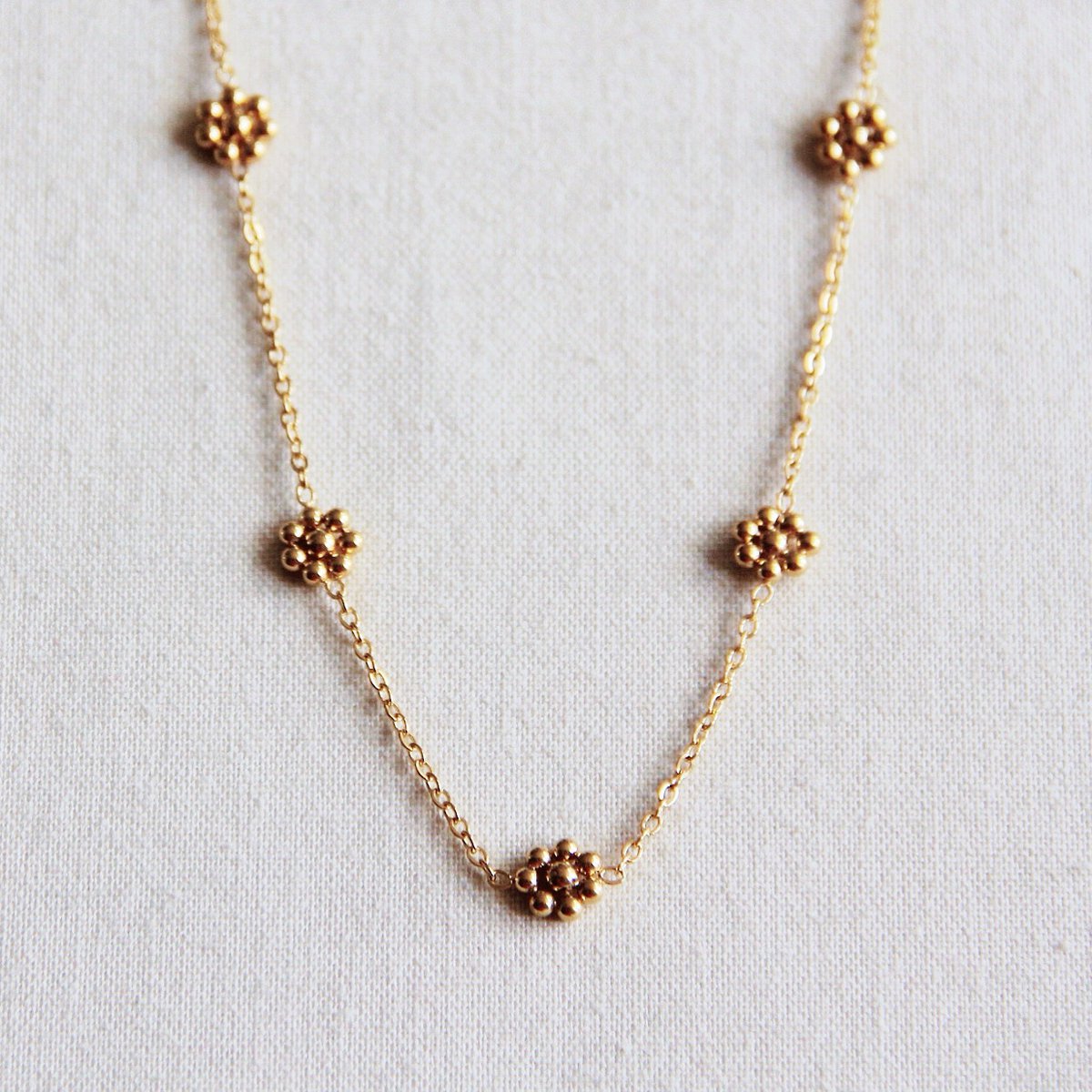 Collier fin fleur marguerite acier inoxydable - doré