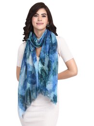 A large, soft, and sustainably-made wool scarf in a vibrant blue and green tie-dye pattern, perfect for adding a touch of style to any outfit.