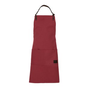 K0015XB | Werkschort van canvas / echt volnerf leer, volants. Bordeaux/Testa Moro-kleur. Antieke nikkelaccessoires. Afmetingen: 70 x 90 x 0,5 cm. Verpakking: Polybag