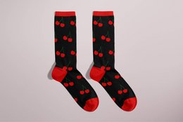 Black socks with red heart-shaped patterns. Suitable for casual or formal wear.