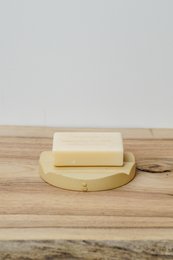 Rectangular sand-colored soap dish made of ceramic material.