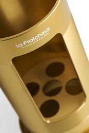 Elegant gold champagne cooler with circular pattern design, suitable for formal events and celebrations.