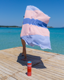 Large, striped beach towel in blue and orange colors, made of soft, absorbent Turkish cotton. Includes a recycled gift box.