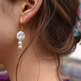 White pearl drop earrings with gold accents