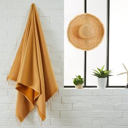 Soft, absorbent terry cloth beach and hammam towel in a variety of colors including gray, mustard yellow, forest green, powder pink, duck blue, navy blue, ocean blue, olive, sahara, and red.