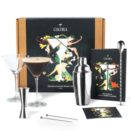 Cocora Martini Set - 9-piece Cocktail Set with Martini Glasses, Extensive Guide, and Luxury Gift Box. Sustainable gift for cocktail enthusiasts.
colors: Gold, Rose Gold, Black, Silver
materials: Glass, Metal
style: Elegant, Sophisticated
shape: Tall, Cylindrical
includes: Martini glasses, cocktail shaker, jigger, strainer, stirrer, recipe guide
text: "Cocora Martini Set", "Martini Glasses", "Extensive Guide incl. 10+ Recipes"
shapes: Martini glass, cocktail shaker