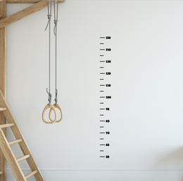 Wall sticker growth chart for kids' room, featuring height measurement markings and hanging rings.