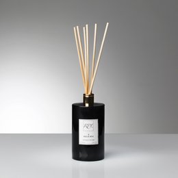 Elegant reed diffuser with a sleek black bottle and wooden reed sticks, offering a luxurious fragrance experience.
