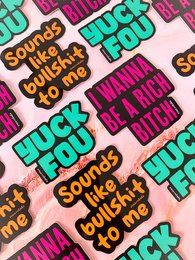 Colorful sticker with text "Sounds like a you problem" and other humorous phrases.