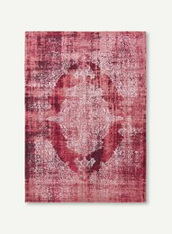 Large red area rug with an ornate, distressed pattern. Suitable for living rooms, bedrooms, or entryways.