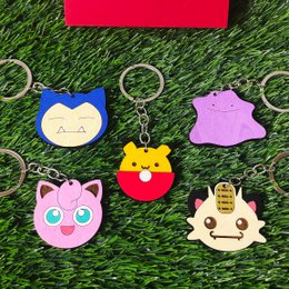 Wooden Arbok Pokémon keychain, custom geek anime gift, nerd video game fan. Purple snake-like Pokémon character with red eyes and fangs.
