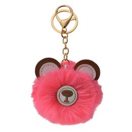 Keychain with a pink fluffy pom-pom and a bear design. The keychain has a gold-tone metal ring and clasp for attaching to bags or keys.