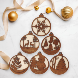 A set of 6 Christmas ornaments in various holiday-themed shapes and designs, including snowflakes, trees, and silhouettes of deer. The ornaments are made of a warm-toned material, possibly wood or a similar natural material, and feature intricate laser-cut patterns.