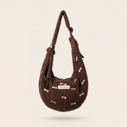Brown dog carrier bag with bone pattern, adjustable straps, small pet transport, teddy design