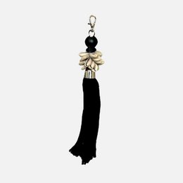 Black tassel keychain with shell and bead accents.