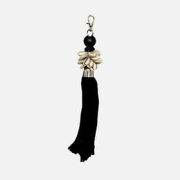 Black tassel keychain with shell and bead accents.