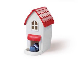 White and red decorative house-shaped coffee capsule holder with a red roof and storage compartment.