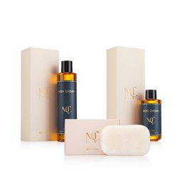 Luxury beauty gift set with golden amber oil bottles, cream soap bar, beige packaging, skincare collection.