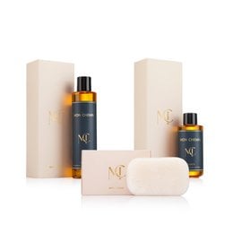 Luxury beauty gift set with golden amber oil bottles, cream soap bar, beige packaging, skincare collection.