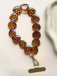 Tortoiseshell brown acrylic beaded phone cord with metal clasp attachment.