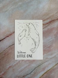 Greeting card featuring a hand-drawn illustration of a baby elephant with the text "Welcome little one". The card is made of white cardstock with a simple, minimalist design.