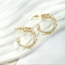 Gold dragon statement earrings with intricate details and a bold, eye-catching design.